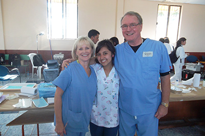 Dr. Roger Allan and wife/hygienist Marcia congratulate one the dental students
